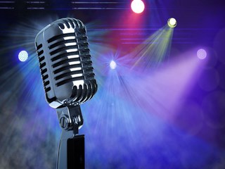Retro microphone with stage lighting background