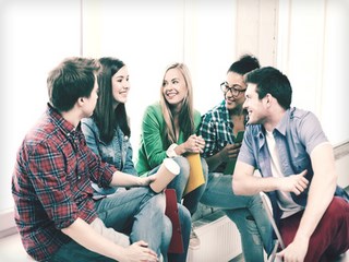 education concept - students communicating and laughing at school